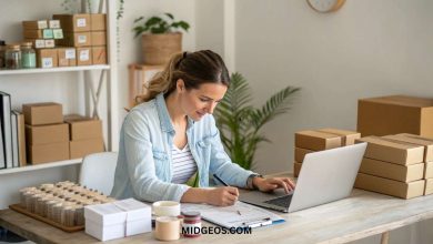 Woman working from home on a small business with a laptop and product samples on desk — How to start a small business from home