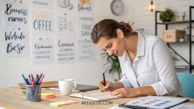 woman writing down small business names ideas in planner at workspace