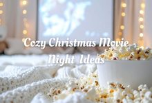 Cozy Christmas movie night setup with blankets, fairy lights, and hot cocoa mugs on a table