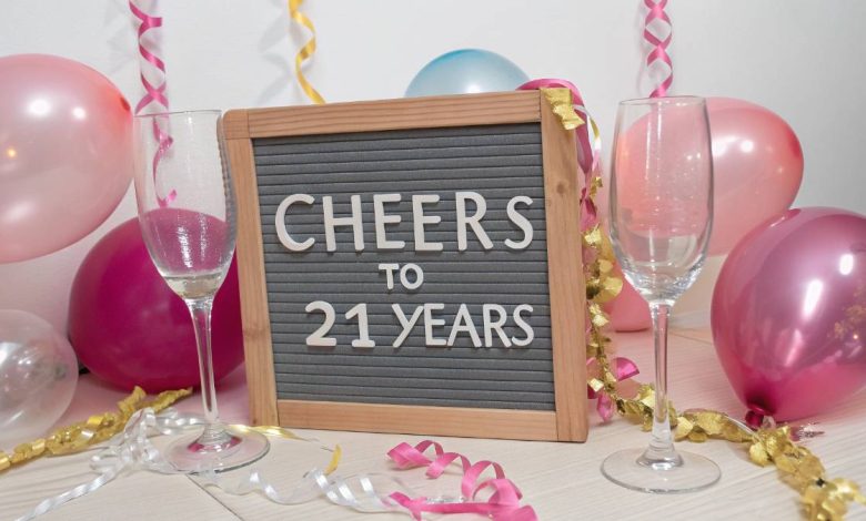 Letter board with “Cheers to 21 Years” and champagne glasses styled for a birthday Instagram post