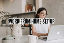 Minimal aesthetic work from home set up with desk, laptop, plants, and cozy lighting in a small home office space