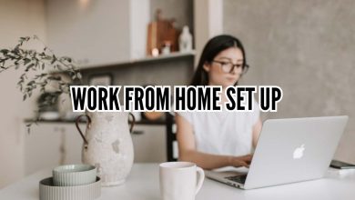 Minimal aesthetic work from home set up with desk, laptop, plants, and cozy lighting in a small home office space