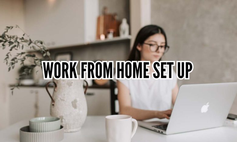 Minimal aesthetic work from home set up with desk, laptop, plants, and cozy lighting in a small home office space